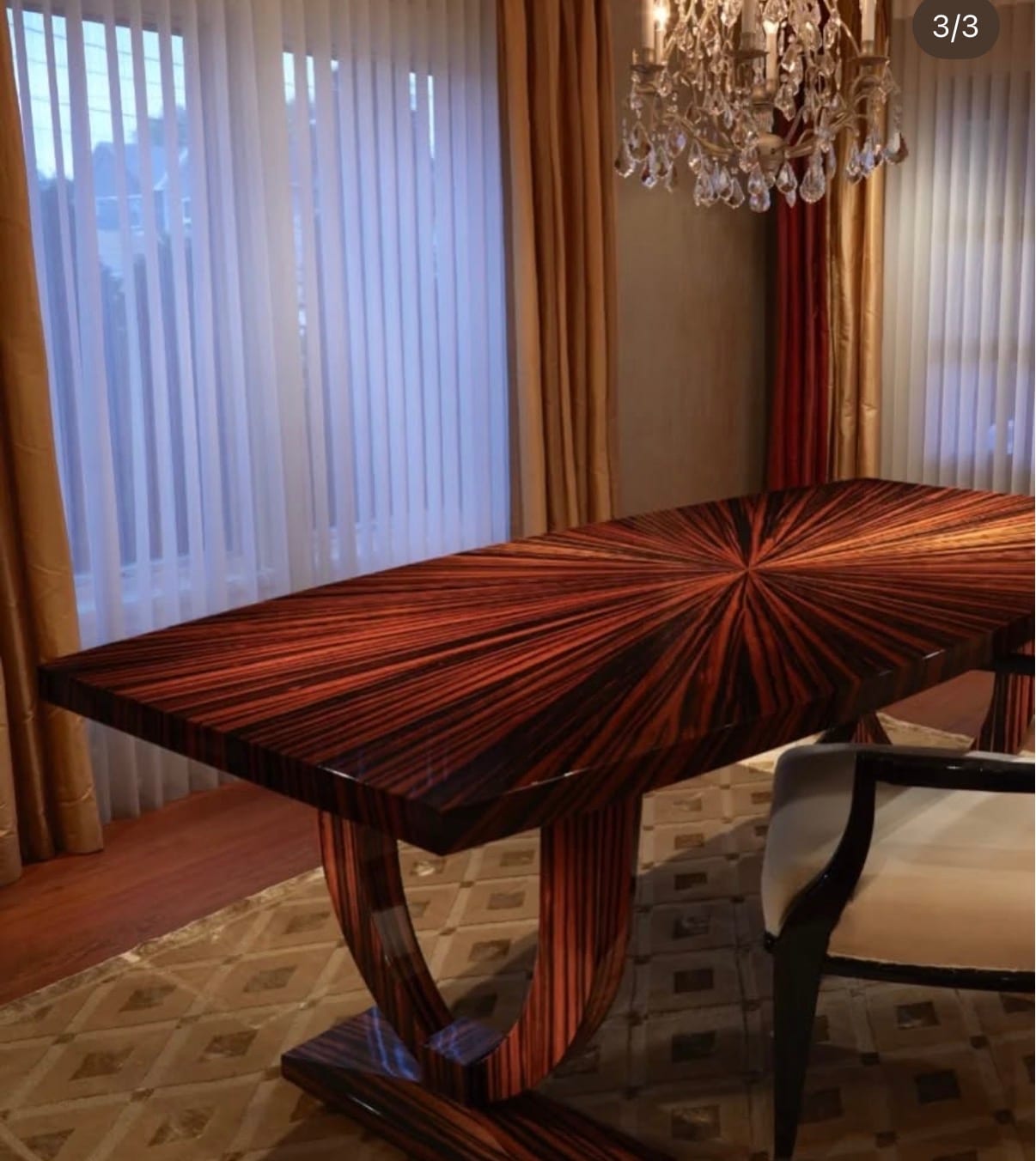 A rectangular ebony dining table in place, its top radial matched so the grain radiates from a single point at the centre
