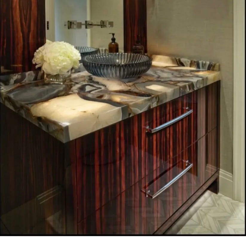 A vanity unit faced in macassar ebony veneer, the black and amber stripe running continuously across the drawer fronts