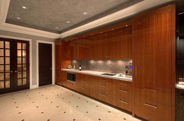 Kitchen cabinetry faced in architectural mahogany veneer panels with a warm red-brown tone