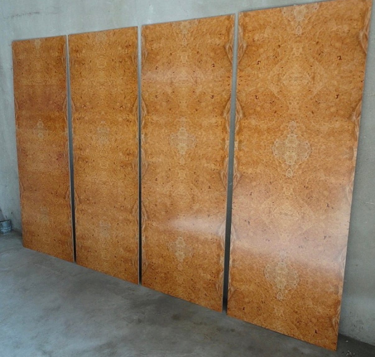 A sheet of architectural plywood faced in maple burl veneer, dense clusters of burl eyes across the panel