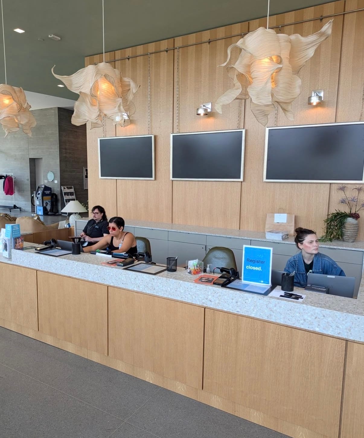 Rift white oak veneer panels installed across a commercial interior wall, grain running vertically and matched across the elevation