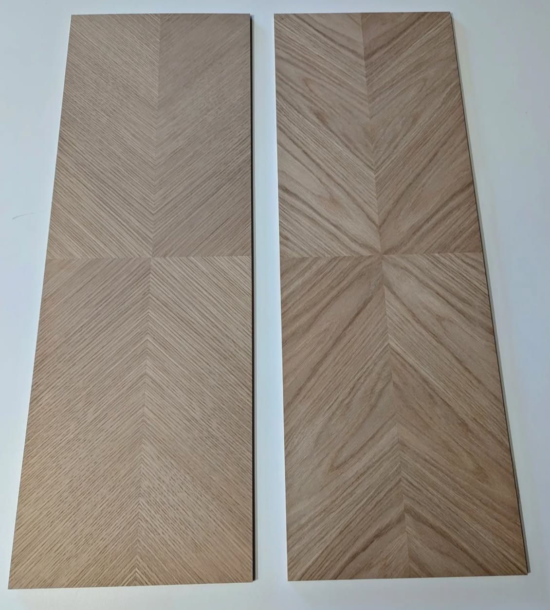 Custom-manufactured rift white oak veneer panels stacked in the shop, straight vertical grain and consistent color