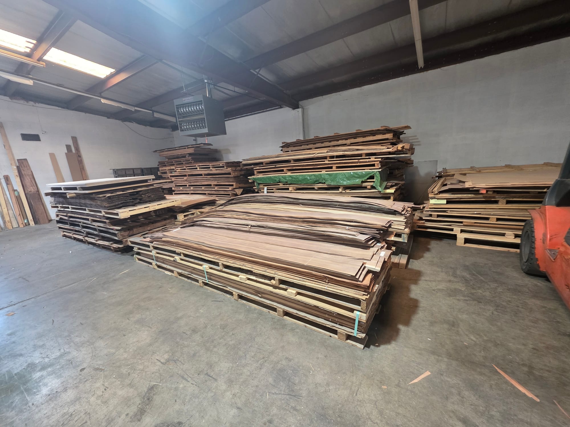 Flitches and bundles of veneer stacked across the floor of the Rosebud Veneer warehouse